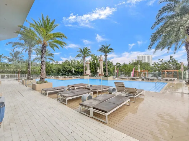 a view of patio with swimming pool and seating