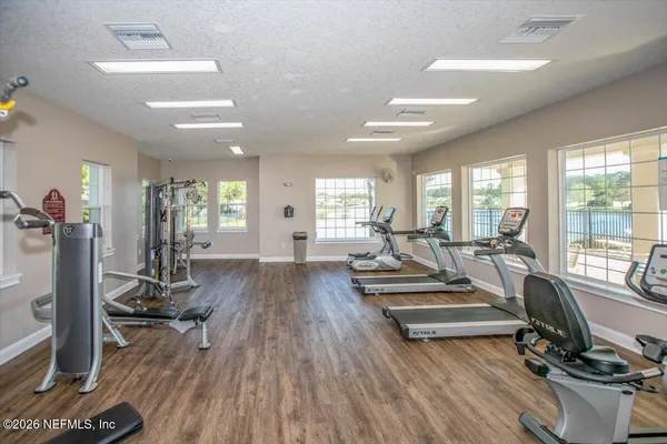 a view of a room with gym equipment and floor to ceiling window