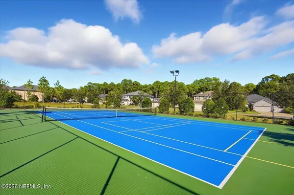 a view of an outdoor space and tennis court
