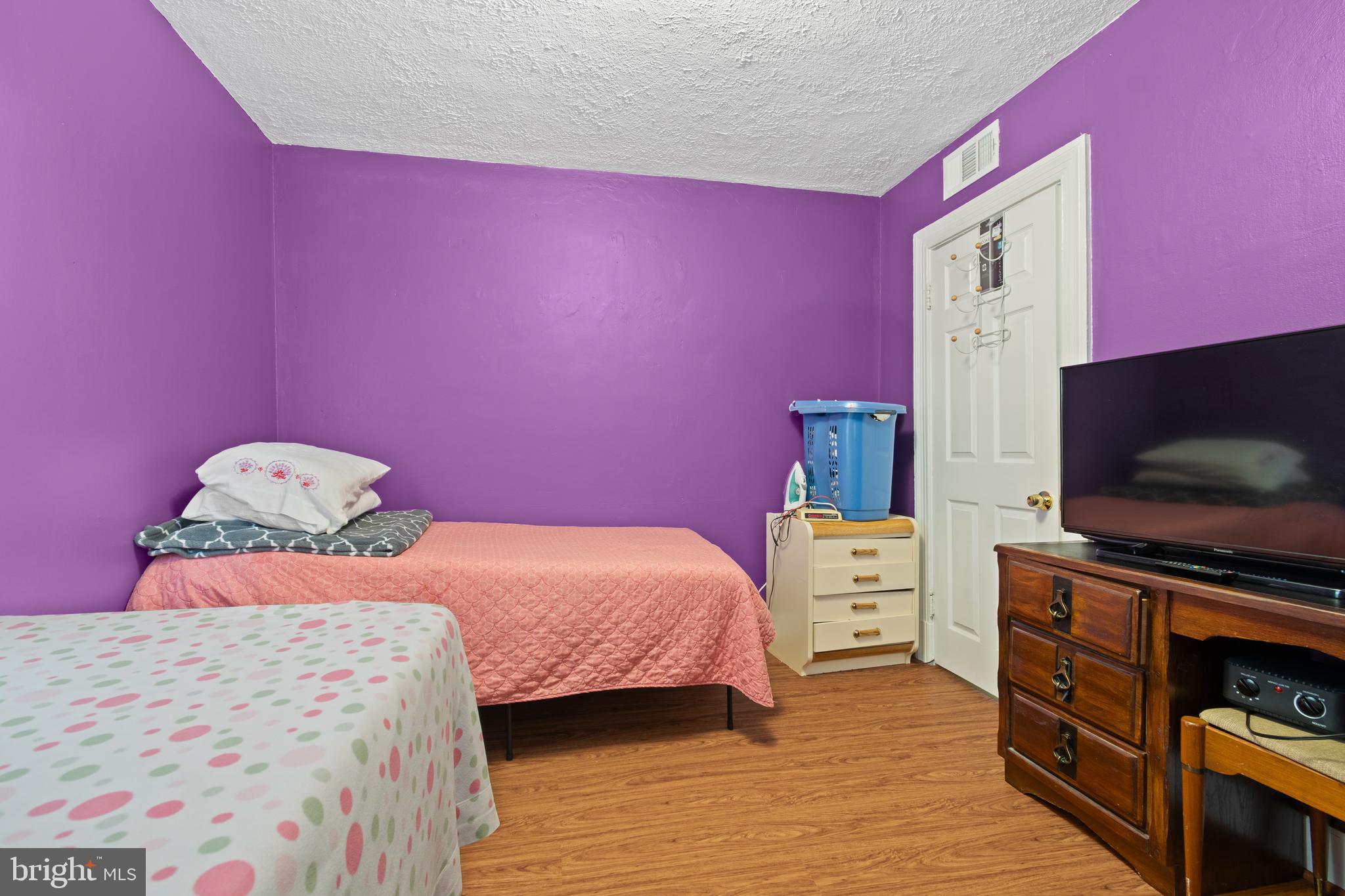 4410 Allies Road Suitland, MD 20746 - Photo 17 of 30 a bedroom with a bed and a flat screen tv
