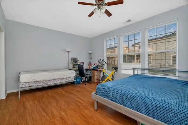 a bedroom with furniture and a wooden floor