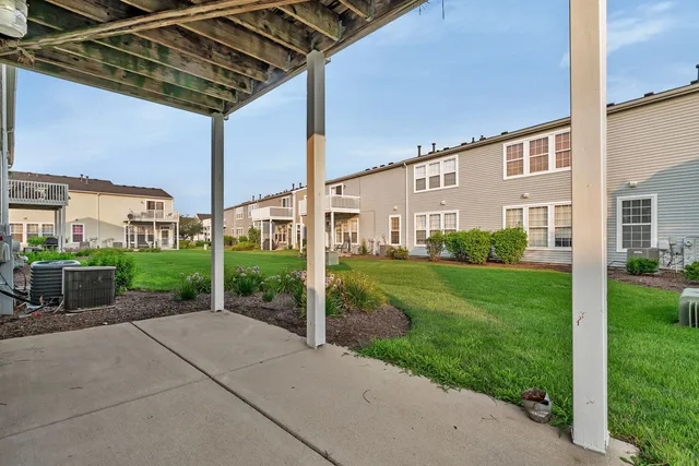 a view of a house with a yard and deck