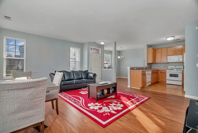 a living room with furniture and kitchen view