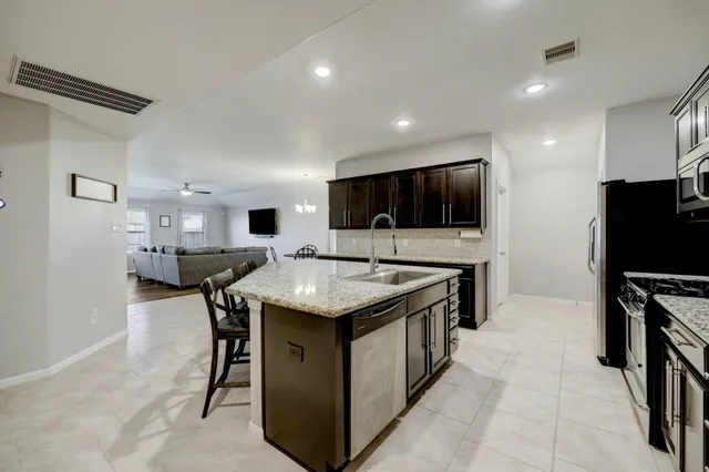 a kitchen with a stove and a refrigerator