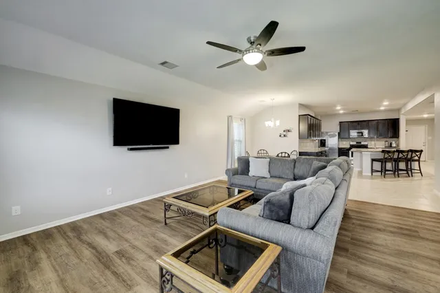 a living room with furniture and a flat screen tv
