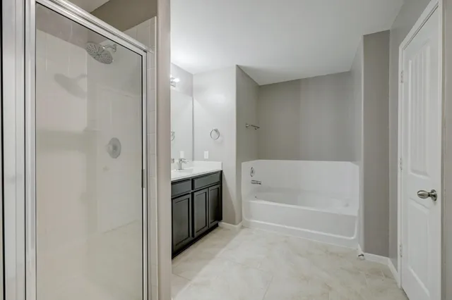 a bathroom with a bathtub shower and a sink