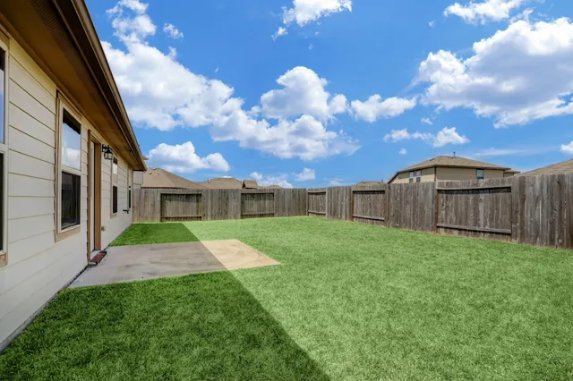 a view of a back yard of the house