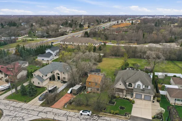 an aerial view of a house with a garden and lake view