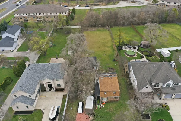 an aerial view of a house with outdoor space