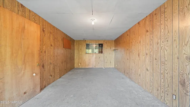 a view of a big room with windows and chandelier fan