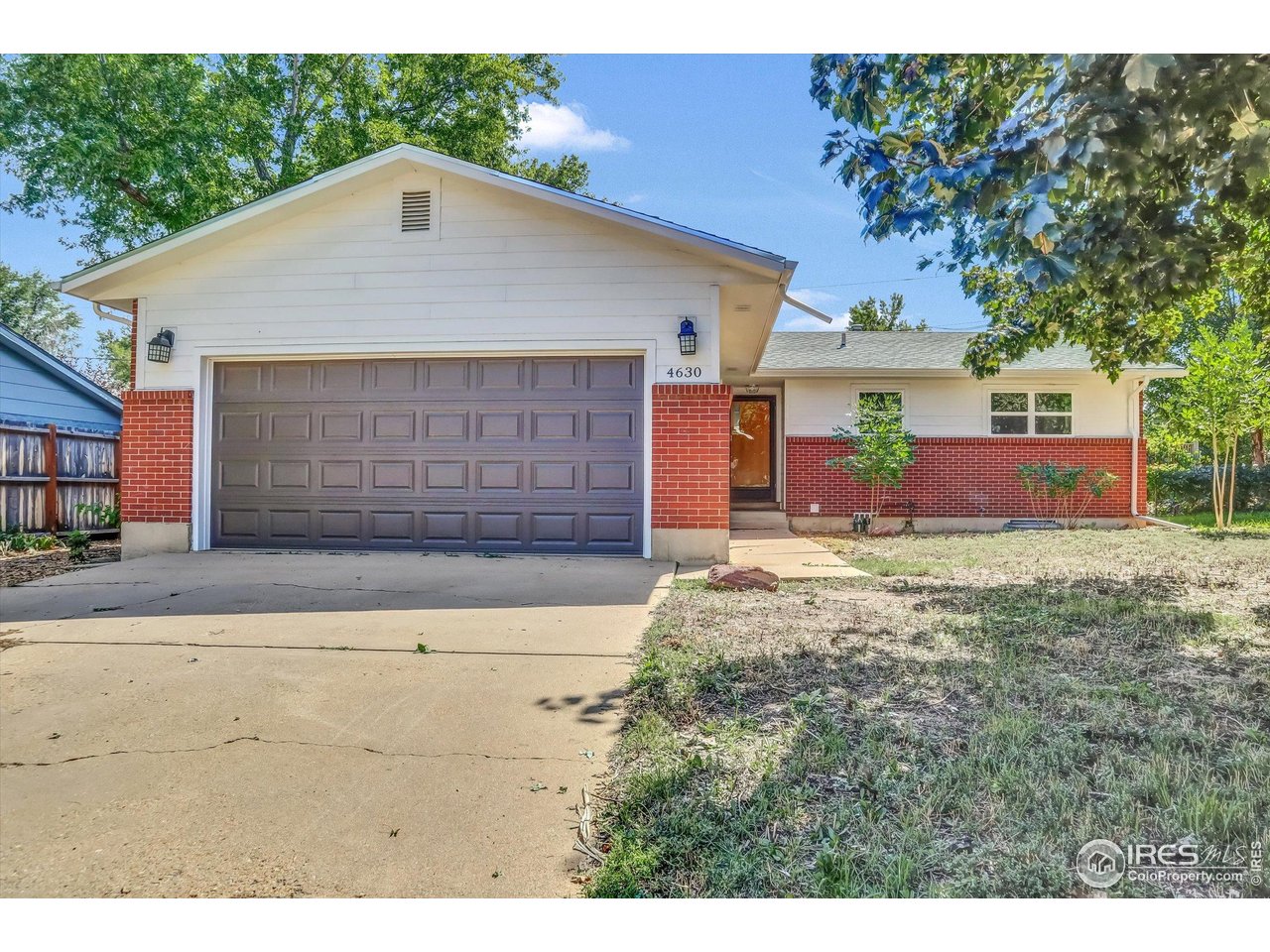 4630 Macky Way Boulder, CO 80305 - Photo 1 of 40 a front view of a house with a yard and garage