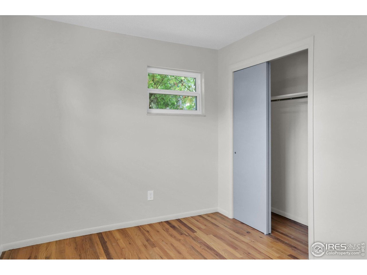 4630 Macky Way Boulder, CO 80305 - Photo 16 of 40 a view of an empty room with wooden floor and a window