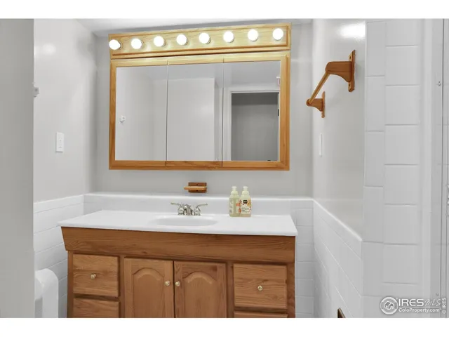 a bathroom with a sink vanity and a mirror