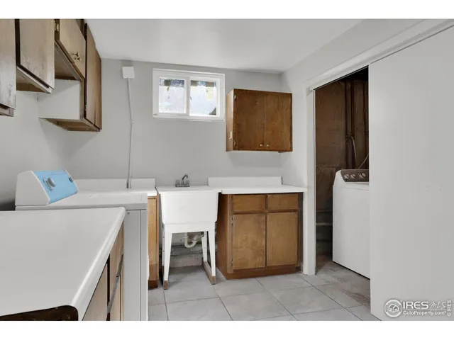 a kitchen with a sink cabinets and chair