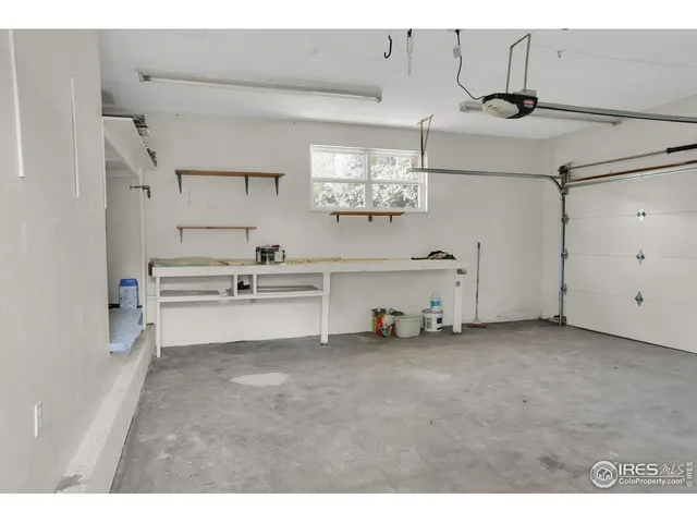 a view of kitchen with cabinets and window