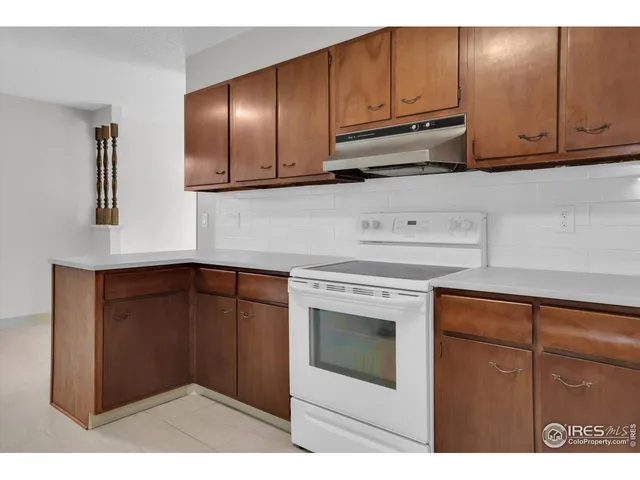 a kitchen with stainless steel appliances granite countertop cabinets and window