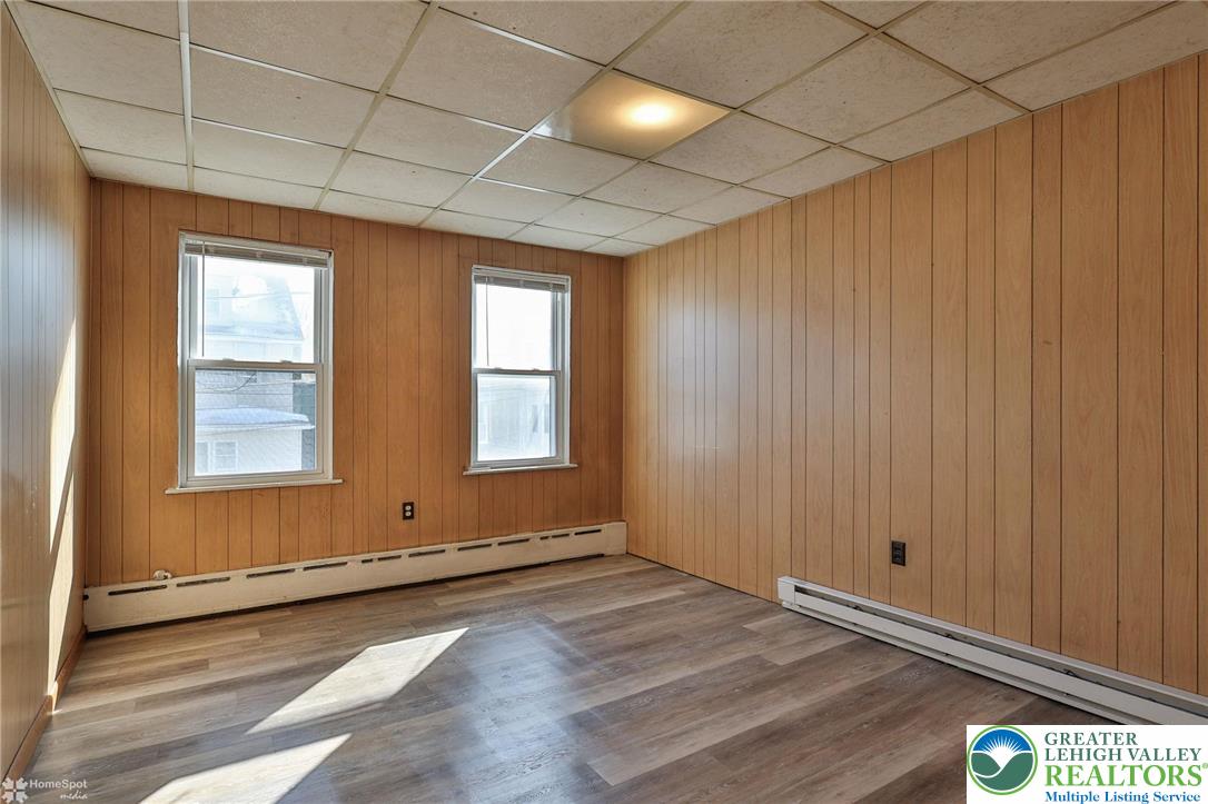 115 East Ruddle Street Coaldale, PA 18218 - Photo 26 of 61 an empty room with wooden floor and windows