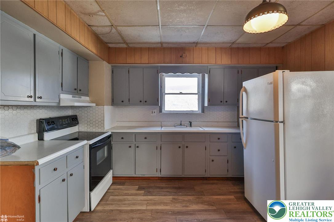115 East Ruddle Street Coaldale, PA 18218 - Photo 34 of 61 a kitchen with granite countertop a refrigerator sink and cabinets