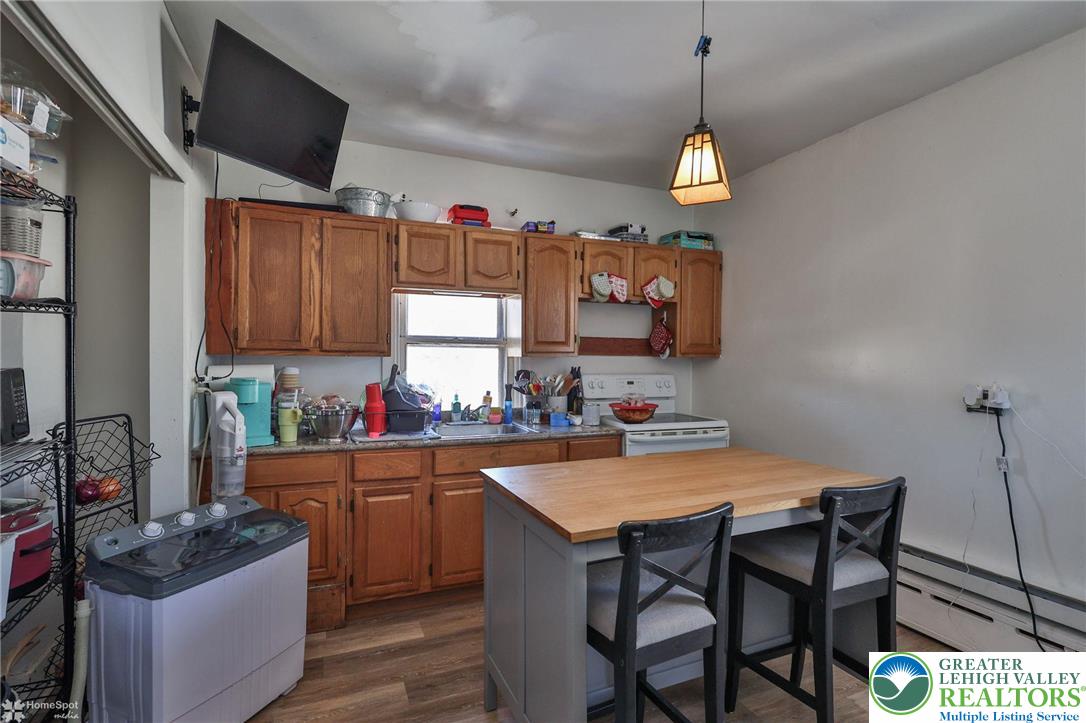 115 East Ruddle Street Coaldale, PA 18218 - Photo 39 of 61 a kitchen with a sink a stove and chairs