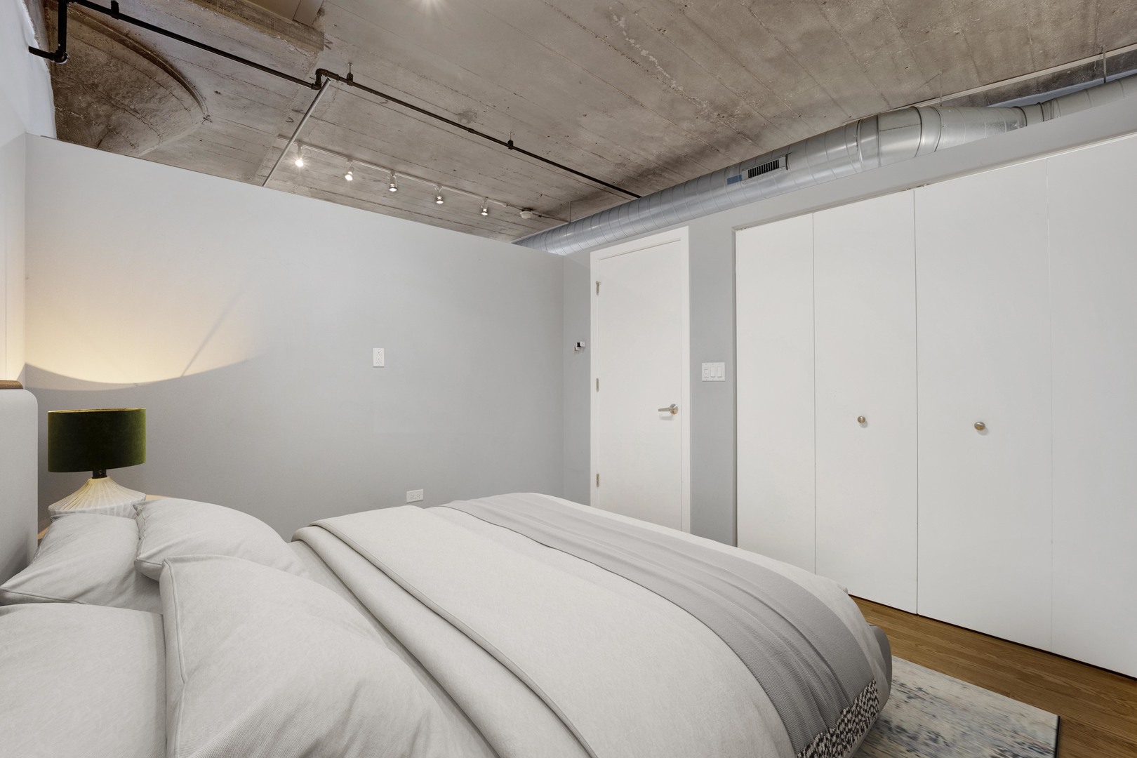 1111 West 15th Street, Unit 224 Chicago, IL 60608 - Photo 13 of 71 a bedroom with a bed and a night stand