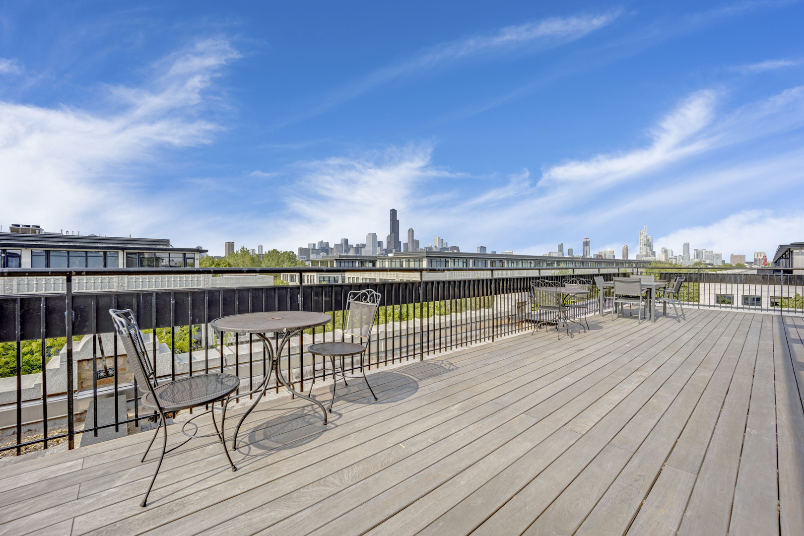 1111 West 15th Street, Unit 224 Chicago, IL 60608 - Photo 22 of 71 a view of a balcony with wooden chairs and city view