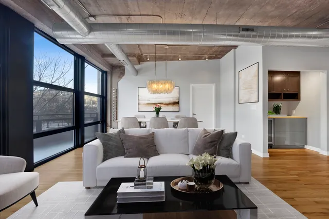 a kitchen with stainless steel appliances granite countertop a sink a stove cabinets and chairs