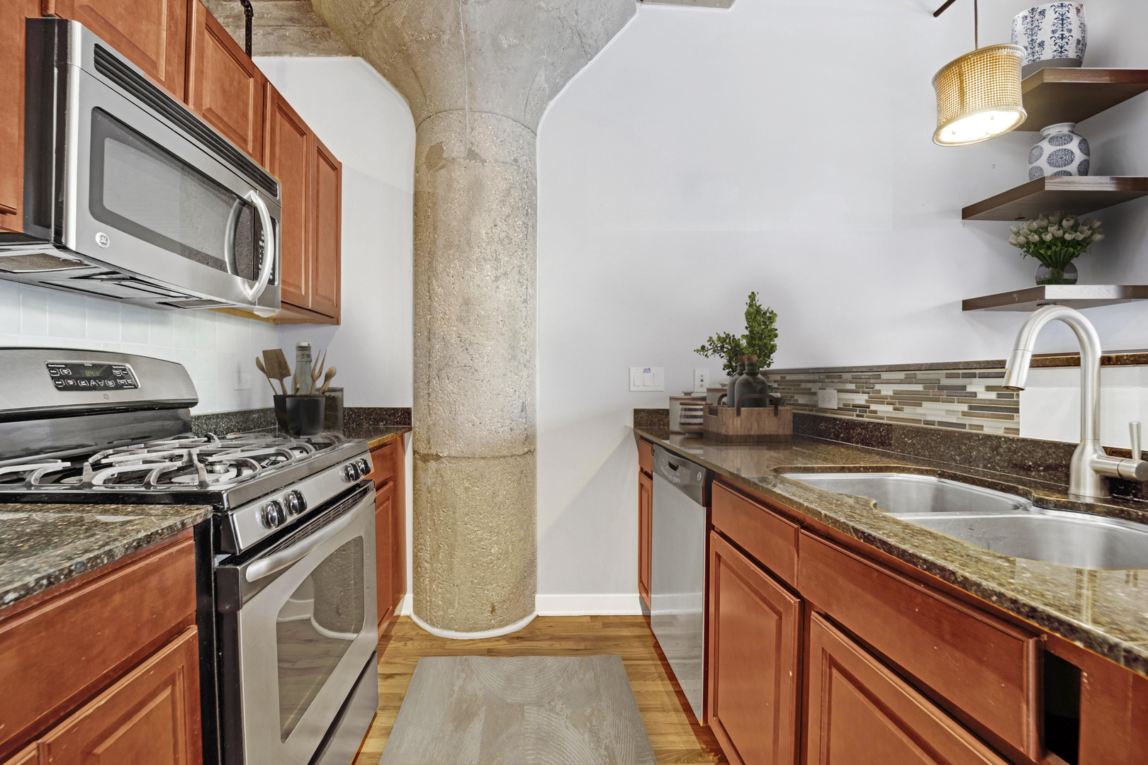 1111 West 15th Street, Unit 224 Chicago, IL 60608 - Photo 8 of 71 a kitchen with stainless steel appliances granite countertop a sink stove and refrigerator
