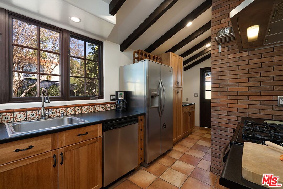3932 Roderick Road Los Angeles, CA 90065 - Photo 15 of 43 a kitchen with stainless steel appliances a refrigerator and a sink