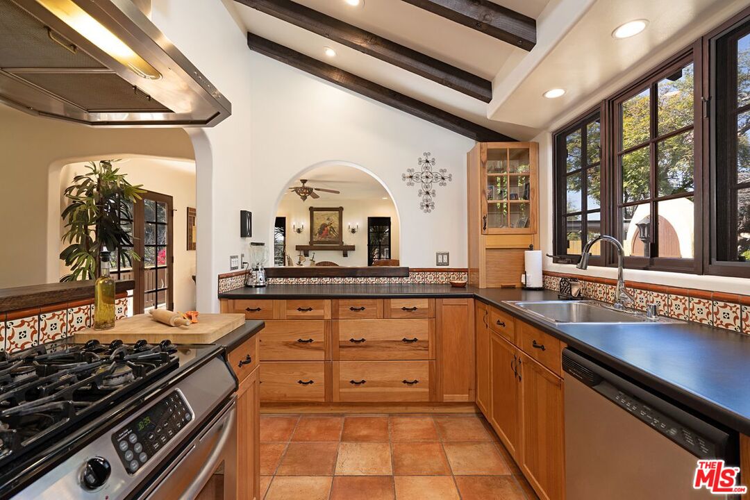 3932 Roderick Road Los Angeles, CA 90065 - Photo 17 of 43 a kitchen with stainless steel appliances a sink stove and cabinets