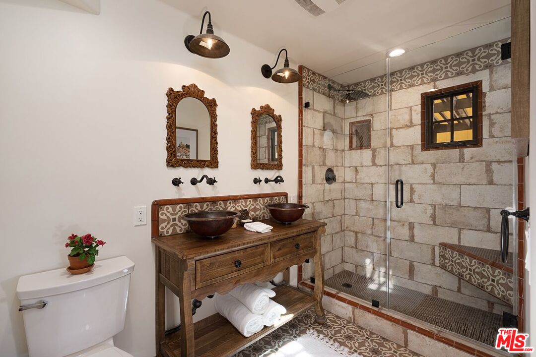 3932 Roderick Road Los Angeles, CA 90065 - Photo 29 of 43 a bathroom with a toilet a sink and mirror