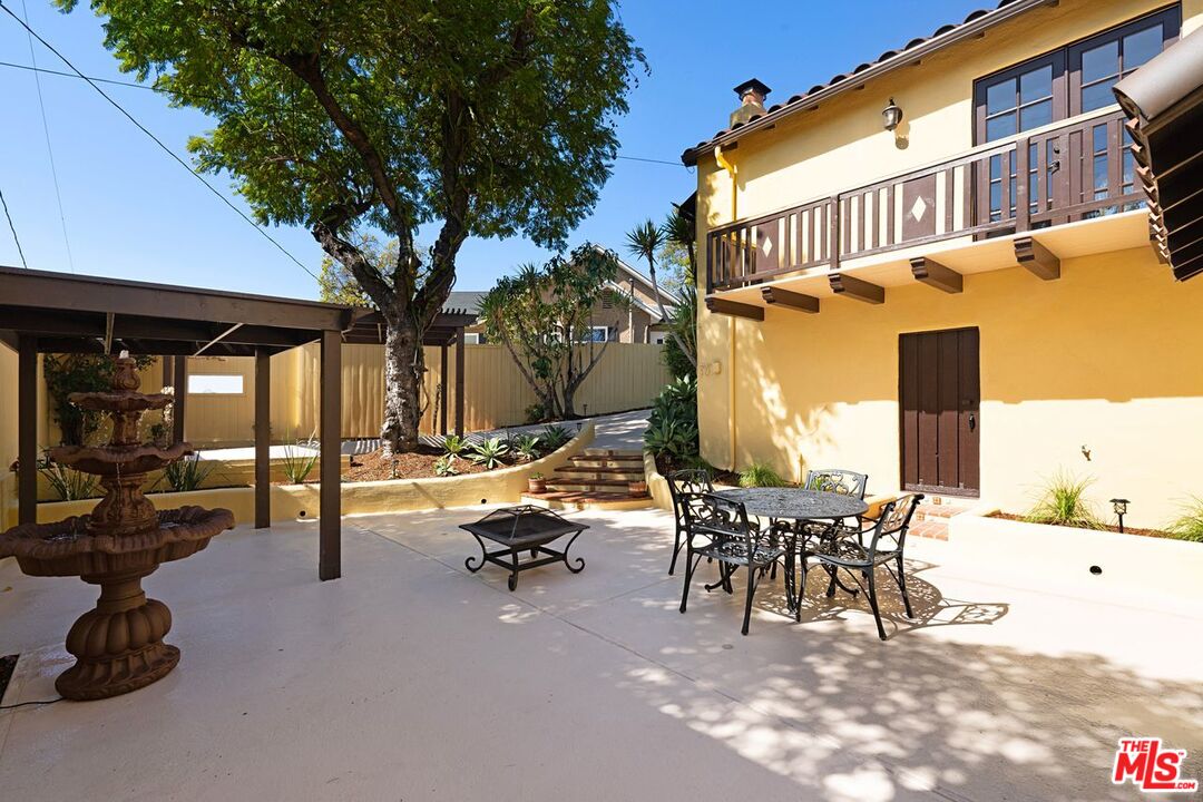 3932 Roderick Road Los Angeles, CA 90065 - Photo 33 of 43 a view of a patio with a table and chairs and floor to ceiling window