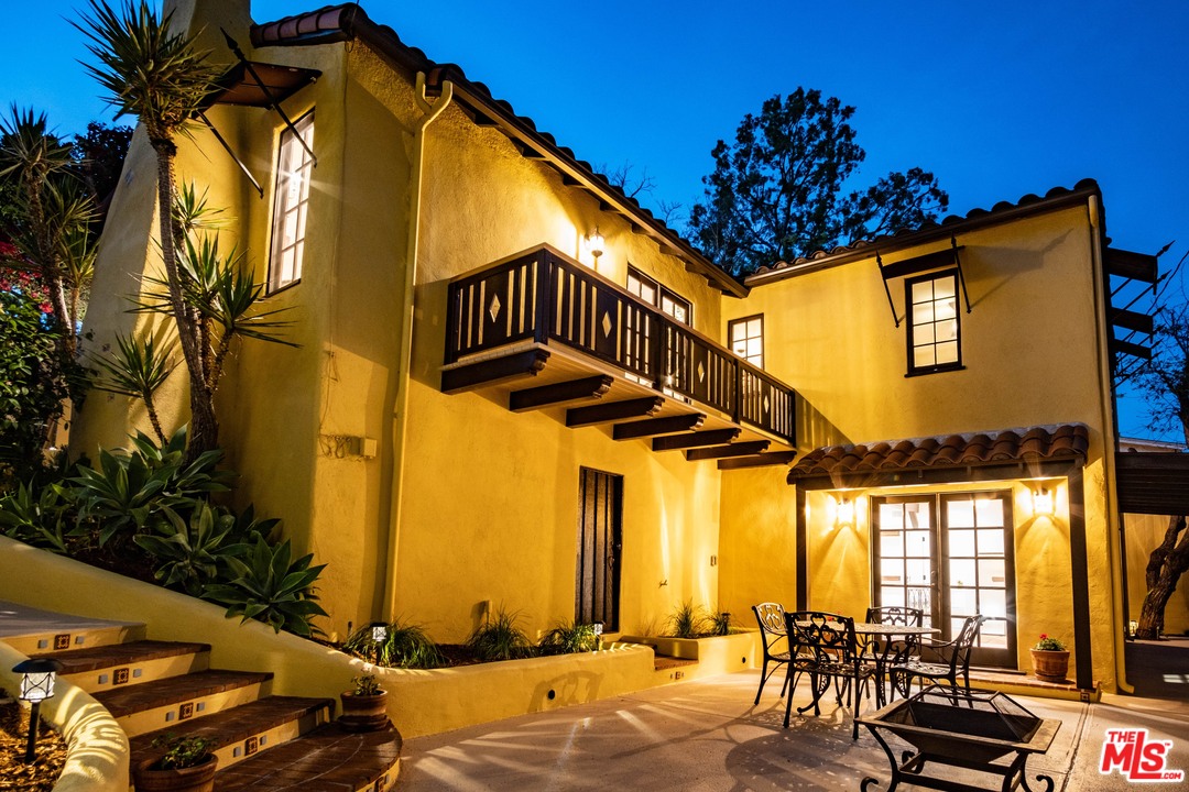 3932 Roderick Road Los Angeles, CA 90065 - Photo 42 of 43 a view of a patio with a table and chairs under an umbrella with a small yard
