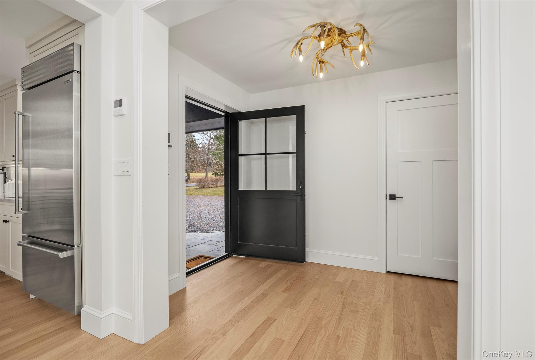 97 Valley Farm Road Millbrook, NY 12545 - Photo 13 of 50 Entryway featuring wood flooring and a chandelier