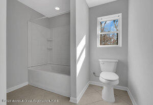 1429 Lakewood Road Manasquan, NJ 08736 - Photo 12 of 26 a white toilet sitting next to a bath tub
