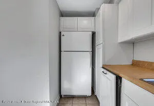a white refrigerator freezer sitting inside of a kitchen