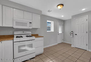 1429 Lakewood Road Manasquan, NJ 08736 - Photo 17 of 26 a kitchen with a stove and a refrigerator