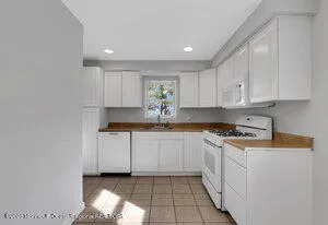 a kitchen with a sink window and cabinets
