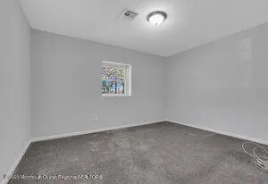 an empty room with a empty space and window