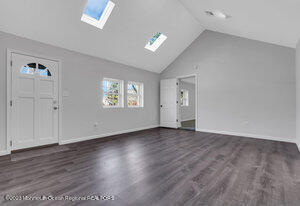 1429 Lakewood Road Manasquan, NJ 08736 - Photo 6 of 26 an empty room with wooden floor and windows