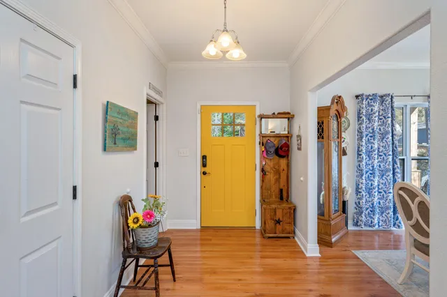 a living room with furniture a rug and a ceiling fan