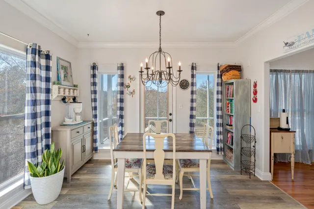 a living room with furniture fireplace and a large window