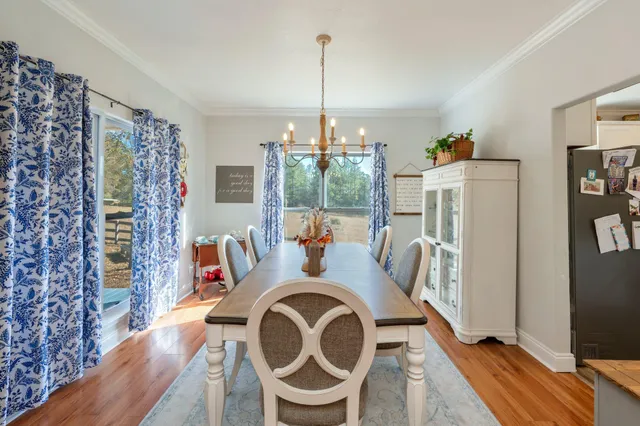 a room with furniture a chandelier fan and a window