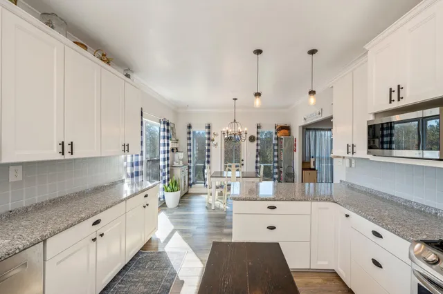 a stove top oven sitting inside of a kitchen