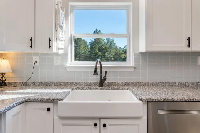 a bedroom with bed and a wooden floor