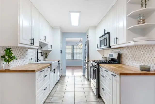 a kitchen with a stove a sink and a refrigerator