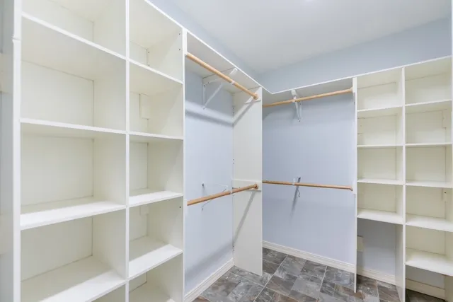 a kitchen with cabinets stainless steel appliances and a counter space