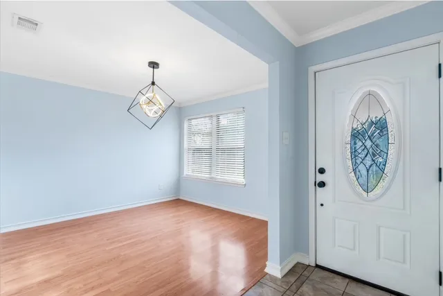 a view of a room with wooden floor and windows