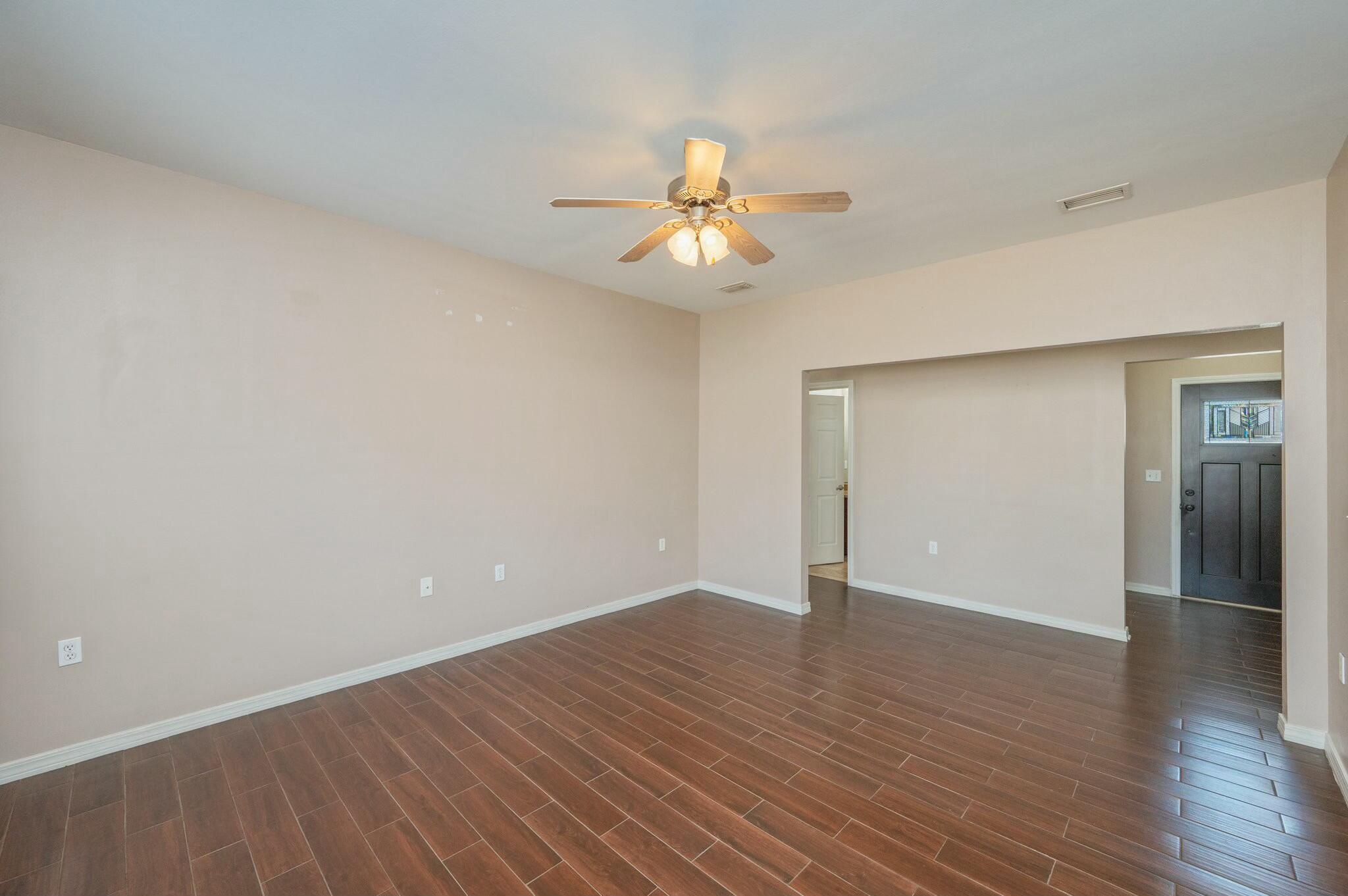 202 Ladue Avenue Crestview, FL 32539 - Photo 11 of 33 a view of an empty room with wooden floor and a ceiling fan