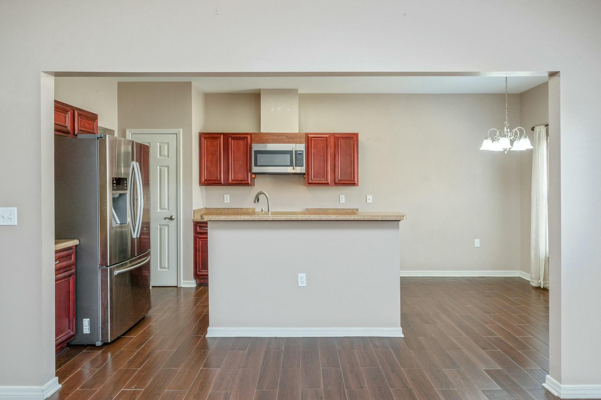 202 Ladue Avenue Crestview, FL 32539 - Photo 12 of 33 a kitchen with stainless steel appliances granite countertop a refrigerator and a stove top oven