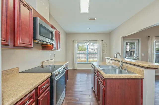 a kitchen with a sink stove and cabinets